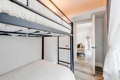 a bedroom with two bunk beds and a living room at Urban Staycation In The Heart Of Downtown PTBO in Peterborough