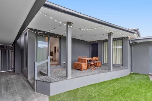 a deck with a table and chairs on a house at Stunning Studio Apartment Near Public Transport in Carnegie