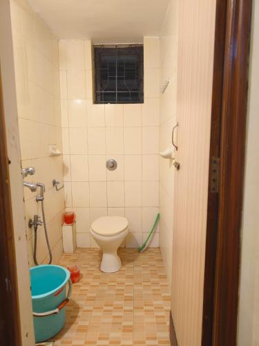 a bathroom with a toilet and a tub at Shraddha hospitality in Calangute