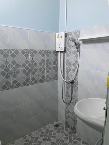 a shower in a bathroom with a sink and a toilet at Banma homestay in Ban Nong Bua