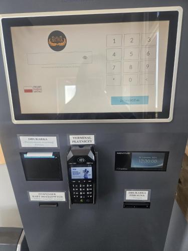 a atm machine with a calculator on top of it at Hostel AgMa in Jasień