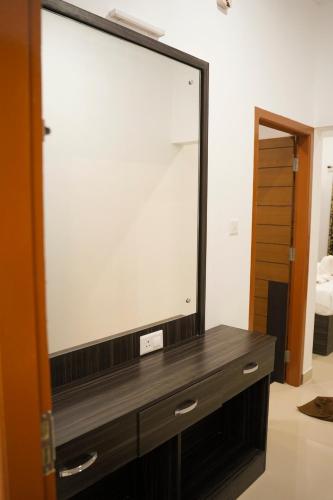 a large mirror on a dresser in a room at Karickanattu Nature Resort in Idukki