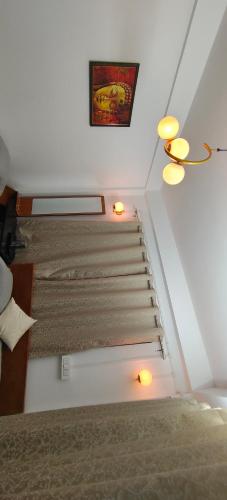 a bedroom with stairs with lights and a picture on the wall at Mirik Homestay in Mirik