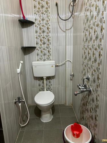 a bathroom with a toilet and a shower and a sink at VARAHA GUEST INN LUXURY ROOMs in Tirupati