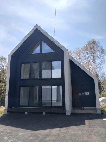 a blue and white building with a large window at Niseko STREAM Villas in Rankoshi