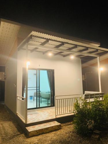 a house with a balcony with a view of the ocean at Suanvadee Resort สวนวดี รีสอร์ท in Don Sak