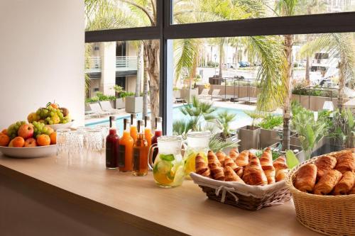 a table with bread and drinks and baskets of food at Riviera Marriott Hotel La Porte De Monaco in Cap d'Ail
