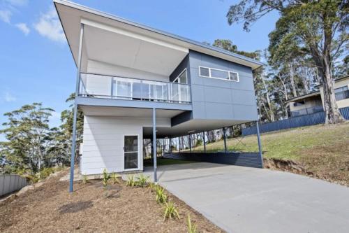 a house on a hill with a pivot door at 3-Bed Coastal Getaway with Direct Beach Access in Long Beach