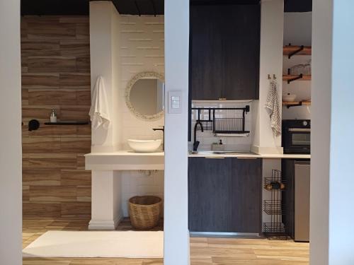 a bathroom with a sink and a mirror at Buckingham Studio in Pinetown