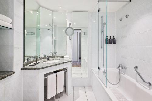 a bathroom with a tub and a sink and a shower at Sheraton Offenbach Hotel in Offenbach