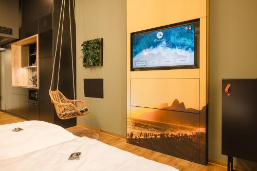a room with a tv and a bed and a television screen at Rioca Stuttgart Posto 6 in Stuttgart
