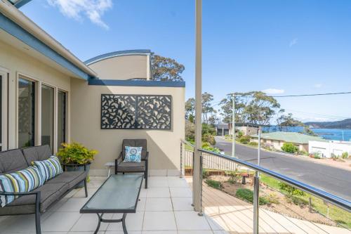 a balcony with a couch and a table at 3-Bed with Beach Views and Entertainment Area in Surf Beach