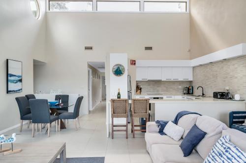 a living room with a couch and a table at 3-Bed with Beach Views and Entertainment Area in Surf Beach