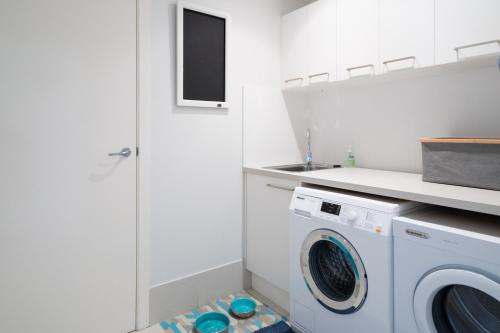 a laundry room with a washer and dryer at 3-Bed with Beach Views and Entertainment Area in Surf Beach