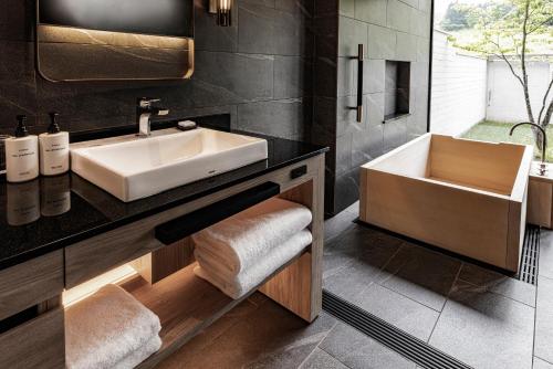 a bathroom with a sink and a mirror at ANA InterContinental Appi Kogen Resort by IHG in Hachimantai