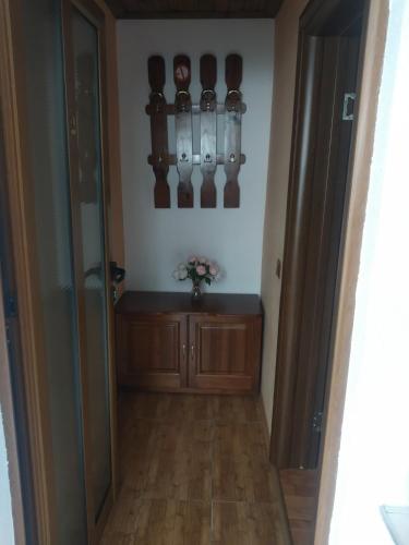 a hallway with a room with a toilet and a table at NIKI HOUSE in Bansko