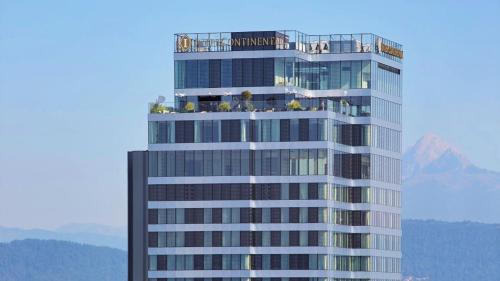 a tall building with people on the top of it at InterContinental - Ljubljana by IHG in Ljubljana