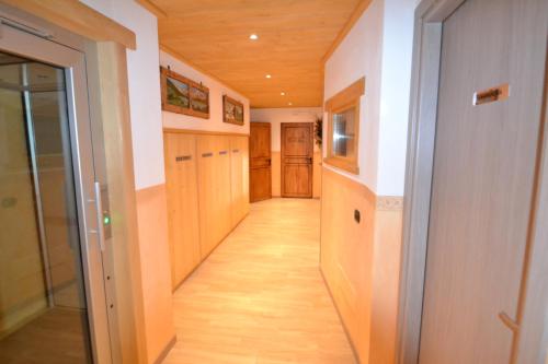 a hallway in a house with wooden floors at Residence Casa Federica in Valfurva