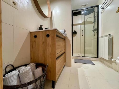 a bathroom with a sink and a glass shower at Prime Loft LA RIOJA in Azarrulla