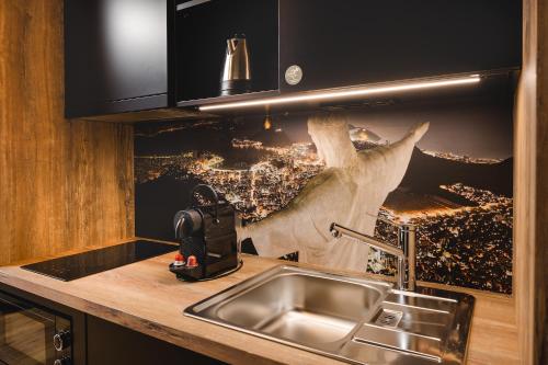 a kitchen with a sink and a picture of a city at Rioca Stuttgart Posto 6 in Stuttgart