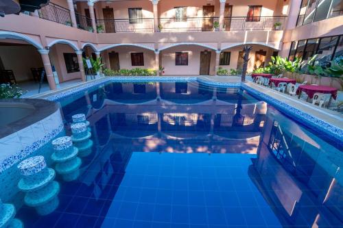 an indoor pool in a hotel at night at Dinah's Tourist Inn Puerto Princesa in Puerto Princesa City