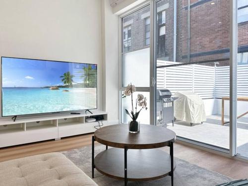 a living room with a large tv and a table at Sydney CBD Newly Renovated Large Terrace in Sydney