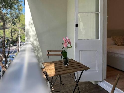 a vase of flowers on a table next to a door at Sydney CBD Newly Renovated Large Terrace in Sydney