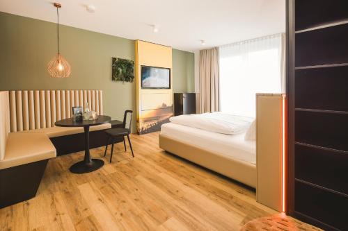 a hotel room with a bed and a table at Rioca Stuttgart Posto 6 in Stuttgart