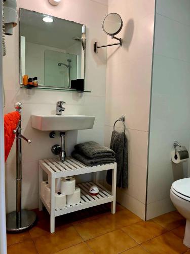 a bathroom with a sink and a toilet at Tossa de Mar - TROPICANA in Tossa de Mar