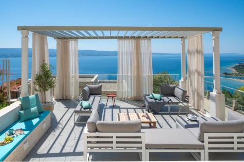 a patio with chairs and a gazebo at Casa GENI-heated pool, 3 bedrooms, sea views in Omiš