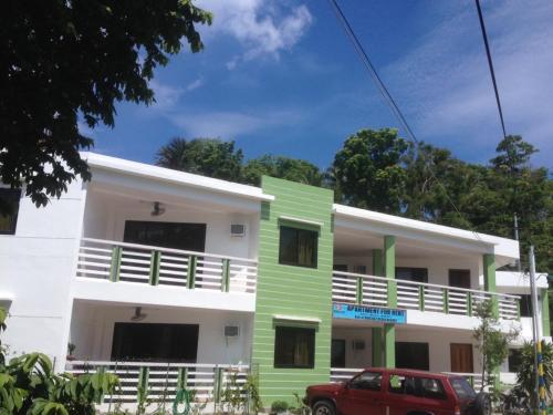 a building with green and white at Badladz Staycation Condos in Puerto Galera