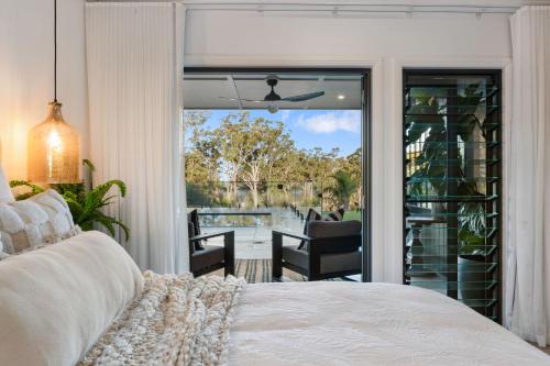 a bedroom with a bed and a sliding glass door at Ridge Retreat in Toowoomba