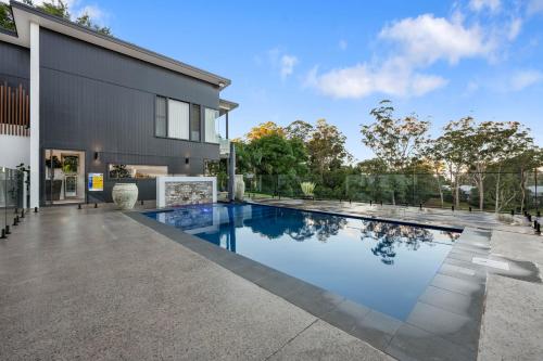 a swimming pool in the backyard of a house at Ridge Retreat in Toowoomba
