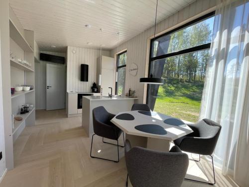 a kitchen and dining room with a table and chairs at Tondikaku Holiday Home in Otepää