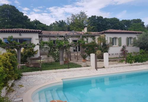 una casa con piscina frente a ella en Magnifique villa de charme avec piscine en Draguignan