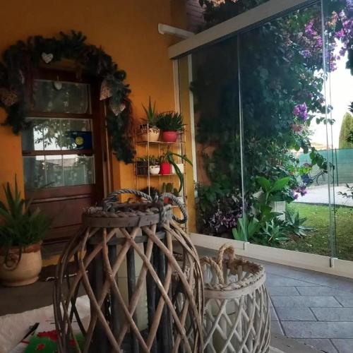 a room with a large window with potted plants on it at Casolare Isabella "Il rifugio dei vinili" and Alice's room in Ponsacco