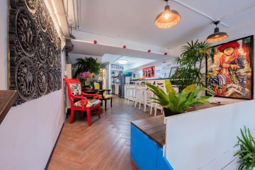a lobby of a restaurant with tables and chairs at Mascotte Hostel Silom in Bangkok