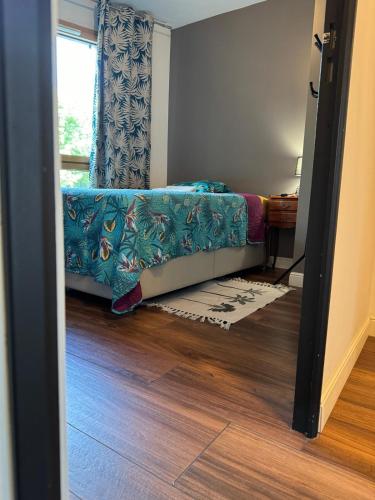 a small bedroom with a bed and a window at Chambre d'hôte près Stade de France by RESERVATI HOME in Saint-Denis