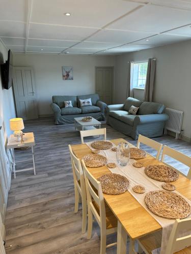 a living room with a table and a couch at The Jockey's Lodge @ Danebury in Stockbridge