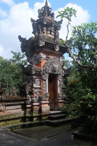 an ornate gate to a building in a park at Gunung Kawi House in Tegalalang