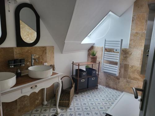 a bathroom with two sinks and a mirror at Gite Le Charme in Cinais