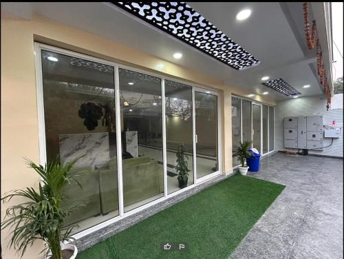 an empty room with a green lawn in a building at Happy Living in Noida