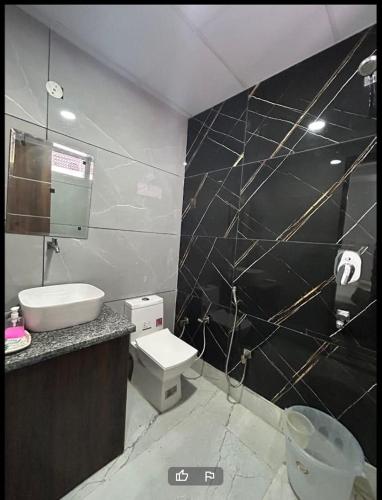 a bathroom with a toilet and a sink at Happy Living in Noida