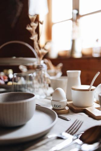a table with plates and bowls and utensils on it at Ferienanlage Villa Maare in Gillenfeld