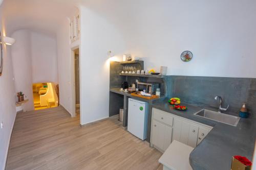 a kitchen with a sink and a counter top at Vivid Caves 1 bedroom Cavehouse in Foinikiá
