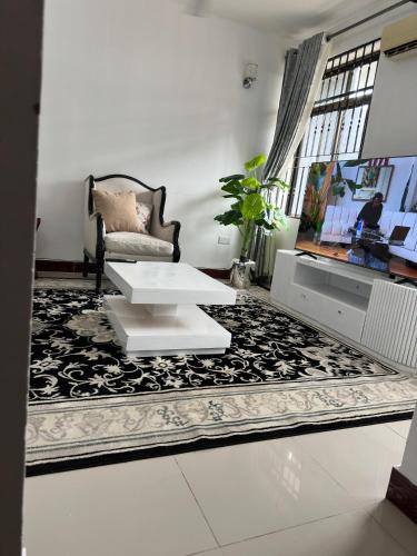 a living room with a white table and a couch at Stay with soniyah 2 in Dar es Salaam