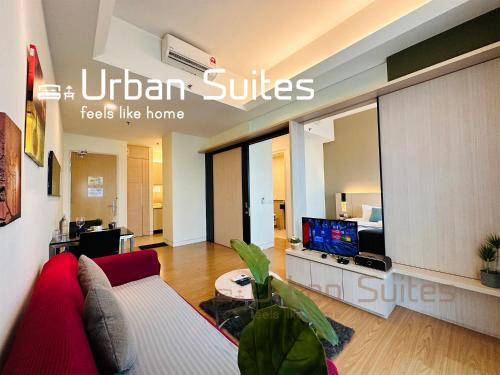 a living room with a red couch and a tv at Urban Suites @ Swiss Garden Residence in Kuala Lumpur