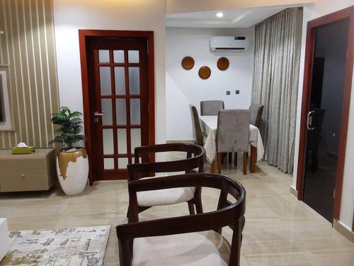 a dining room with a table and chairs in a room at Comfort and Style. in Benin City