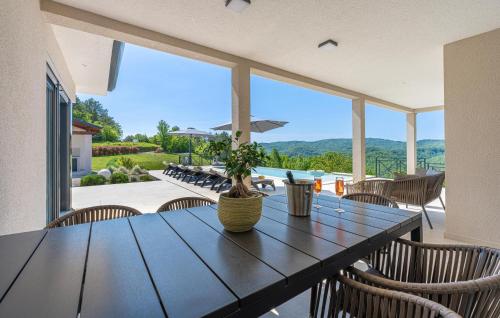 a dining room with a table and chairs with a view at Stunning Home In Hum With Sauna in Hum