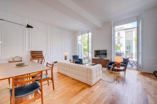 un salon avec un canapé et une table dans l'établissement Le Trésor - Appt dans le Triangle dOr de Bordeaux, à Bordeaux